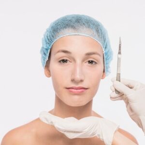 cosmetologist holding scalpel near woman face 23 2147929579